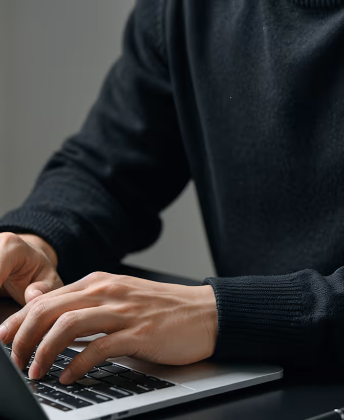 Hands at a laptop.