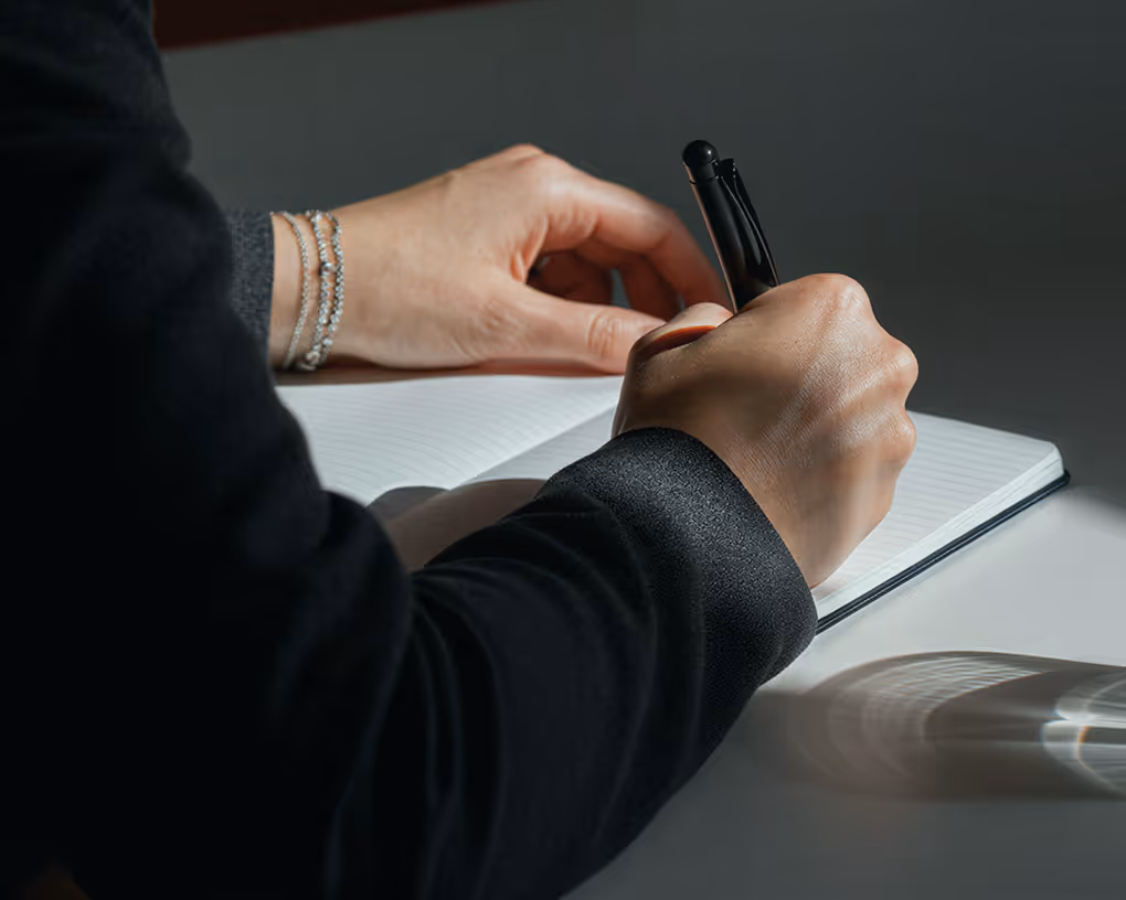 Hands writing notes.